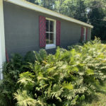 Side of garage of house for sale near Mullet Lake